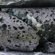 Basalt rock containing carbonates, which are solids that have trapped carbon dioxide.